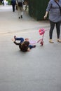 Street accident - kid girl fell down from child scooter