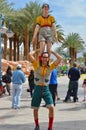 Street acrobats smiling, dressed in funny clothes