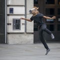 A street actor with a head-mounted horse dancing on the street