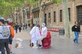 A street actor puts on make-up before a performance