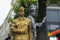 Street actors, young man and girl, performing outdoor in costumes of the Soviet Red Army soldier and sailor