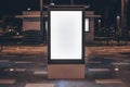 Street advertising mock up template with copy space. Outdoor commercial banner with white empty display on the night