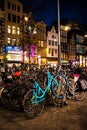 Street of Amsterdam during the night. Tourists, coffe shops, bicycle parking and colorful city lights