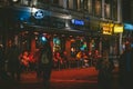 Street of Amsterdam during the night. Tourists, coffe shops, bicycle parking and colorful city lights