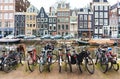 Street in Amsterdam, yachts on the canal and bicycle parking in the foreground Royalty Free Stock Photo