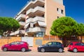 Street with Apartment building in Lloret de Mar with parked cars near the house, Costa Brava, Spain