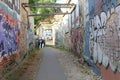 Street art corridor in Uzupio, an artistic district in Vilnius, Lithuania Royalty Free Stock Photo