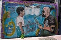 Street art in Buenos Aires, wall painting, graffiti, boy listening to saxophone player. Argentina.