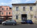 Street art of chained cars in the facade of a house to Rome in Italy.