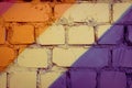 Street art detail. Colour block. Purple or violet, orange and yellow brick wall texture background. Geometric pattern on house wal Royalty Free Stock Photo