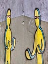 Drawing on which two aliens, similar to humans. Yellow alien, wearing glasses, with arms raised