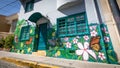 Street art with green, flourish art at house facades in the streets of Valparaiso, Chile.