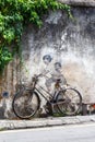 Street Art mural boy and girl on bicycle on a wall portrait format in George Town on Penang island in Malaysia