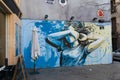 Street art of a young woman covering her face with one arm on th Royalty Free Stock Photo