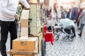 Street artist busker man playing music by organ barrel vintage wooden box machine at crowded old european city France Royalty Free Stock Photo