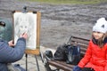 Street artist drawing a caricature of a couple in Lviv