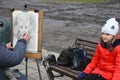 Street artist drawing a caricature of a couple in Lviv