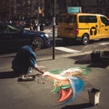 Street artist drawing with chalk