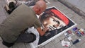 Street artist drawing classic portraits in public