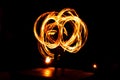 Street artist fire juggling performance. Light painting and long exposure picture to form trails. Phi Phi Island, Thailand.