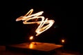 Street artist fire juggling performance. Light painting and long exposure picture to form trails. Phi Phi Island, Thailand.