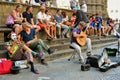 Italians enjoying a summer day in Florence , Italy with street artists and spectators