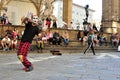 Clown street artist in Italy performing in front of a crowd in Florence city