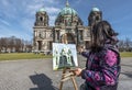 Street artist, painting Berlin Dom