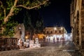 Street artist painting drawings on Old town of Rhodes city at night in Greece Royalty Free Stock Photo
