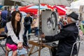 Street artist is painting a woman in Montmartre, Paris Royalty Free Stock Photo