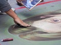 Street artist paints with chalk on the pavement Royalty Free Stock Photo