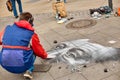 A street artist paints a realistic portrait on the floor of a city square. Street art Royalty Free Stock Photo