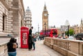 Street artist perform in front of a red phone booth Royalty Free Stock Photo