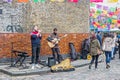 Street artist performance with guitar at Columbia Road Flower Market in London
