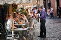 A street artist playing his bandoneon for people on the street in Trastevere, Rome, Italy