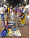 Street artist selling her art to finance her travels . Jalan Alor Kuala Lumpur Malaysia