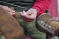 A street artist sewing manufacturing with traditional spinning wheel