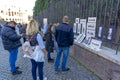 street artists selling paintings and tourists watching. between the coliseum and the entrance to the palatine hill, Rome, Italy