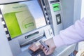 Street ATM close-up. A man uses to issue money Royalty Free Stock Photo