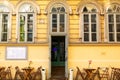 A street bad square at the entrance to a vintage cafe in the city of old Europe