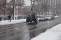 Street in bad weather in winter. Cars are driving on a slippery road. There is a snowstorm.