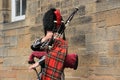 The street bagpiper in the city Edinburgh in Scotland. Royalty Free Stock Photo