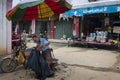 A street barber cutting the hair of a client in a street market at the Fuli Village in the countryside of southern China