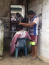 Street barber in a poor village