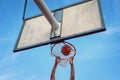 Street basketball athlete performing slam dunk on the court Royalty Free Stock Photo