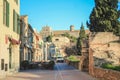 Street behind the city wall in Alcudia, Church of Sant Jaume in the background - Mallorca, Spain Royalty Free Stock Photo