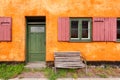 Street bench at front of colorful house. Facade of historical brick building in Copenhagen, Denmark