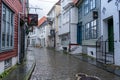 Street of Bergen city in a rainy day. A lot of historical wooden houses and road from paving stones. Royalty Free Stock Photo