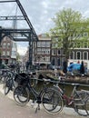 Street with bicycles and bridge along the canal and old buildings of Amsterdam in the city of Amsterdam Royalty Free Stock Photo