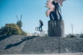 Street biker with a bike practicing free style and jumping at t